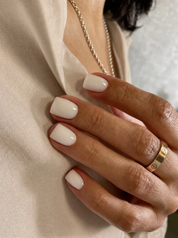 Short square nails with a milky gel finish after a Russian manicure