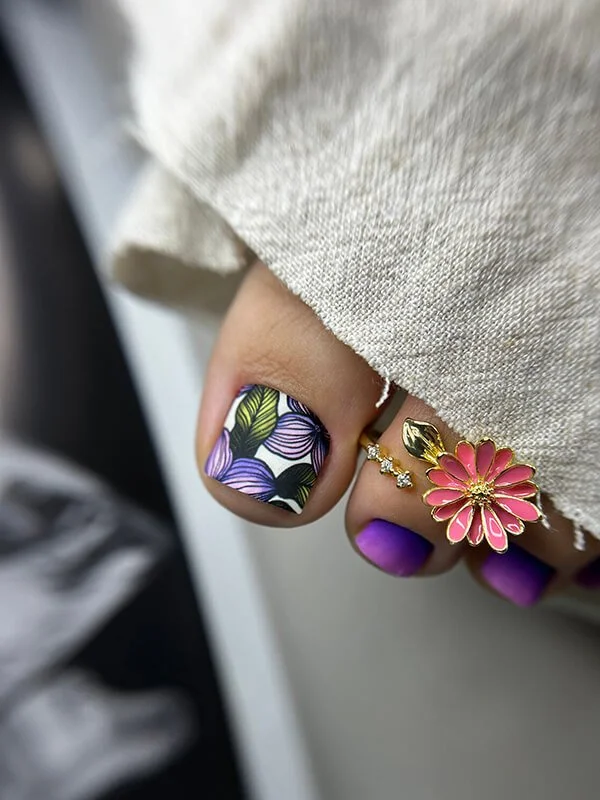 Russian dry pedicure with purple gel polish and detailed floral nail art
