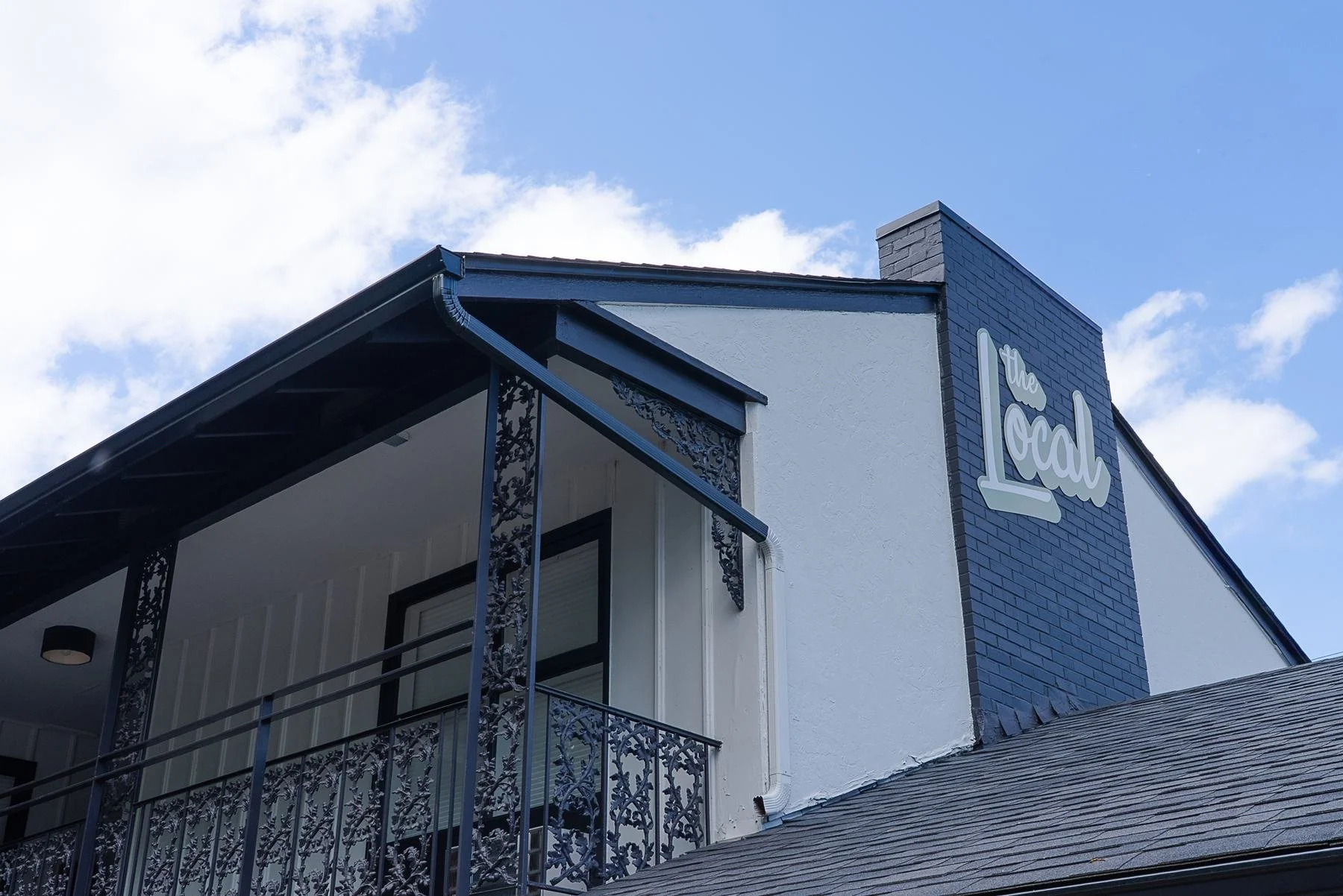 The Local Motel building and sign against a blue sky