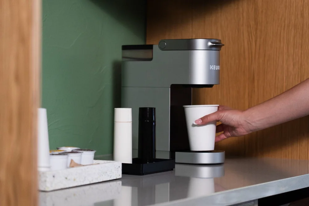 Coffee being poured at the in-room coffee bar