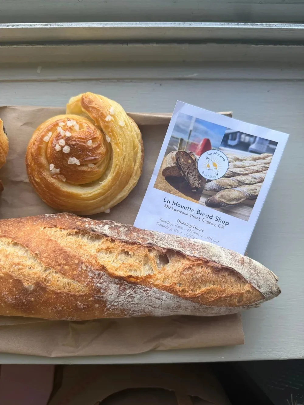 A La Mouette baguette and pastry with the shop card
