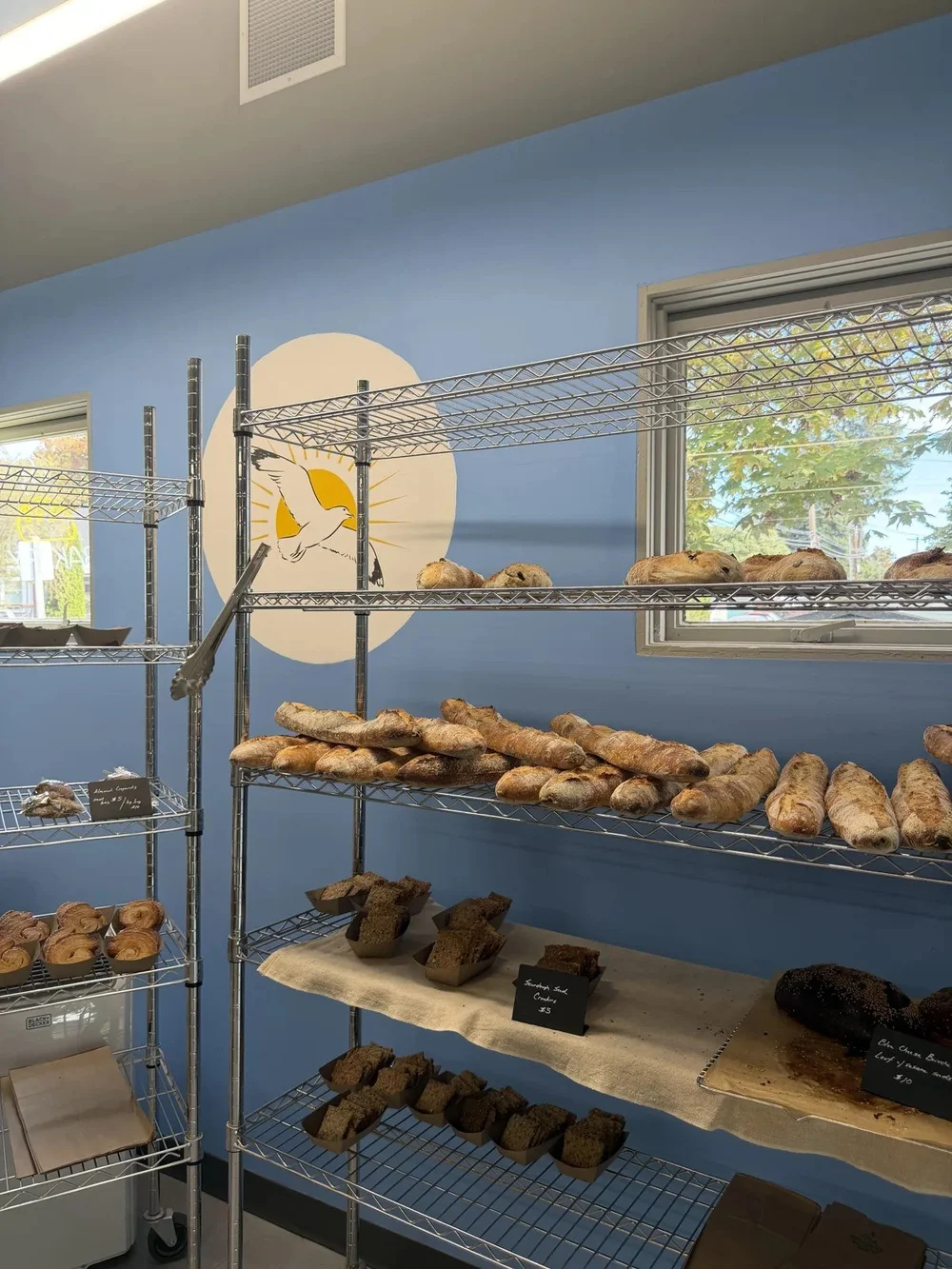 Loaves and pastries on the shelves inside La Mouette