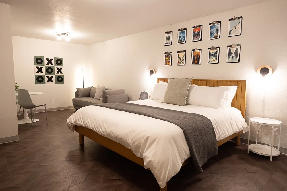 Room 105 with king bed, sofa and tic tac toe wall art