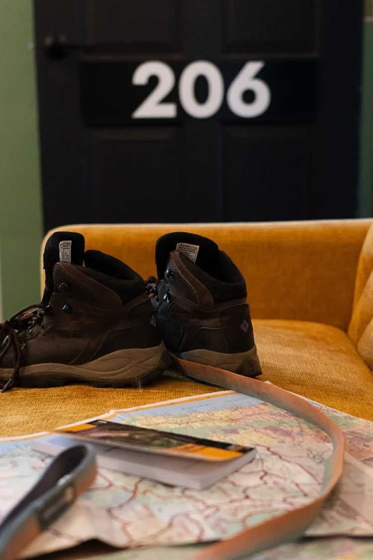 Hiking boots beside door 206