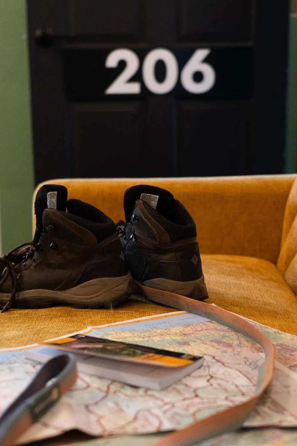 Hiking boots beside door 206