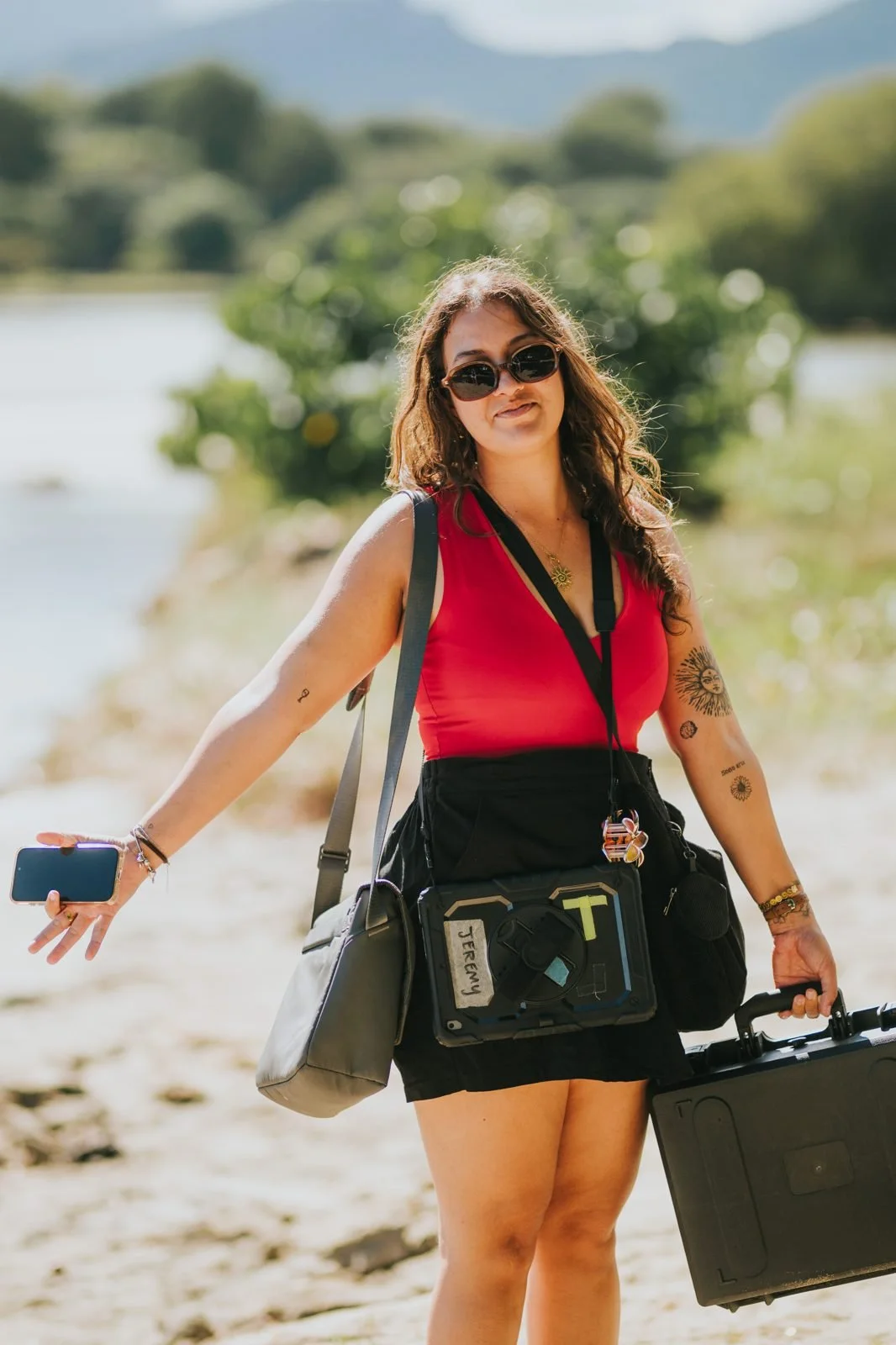 Crew member carrying equipment on the beach