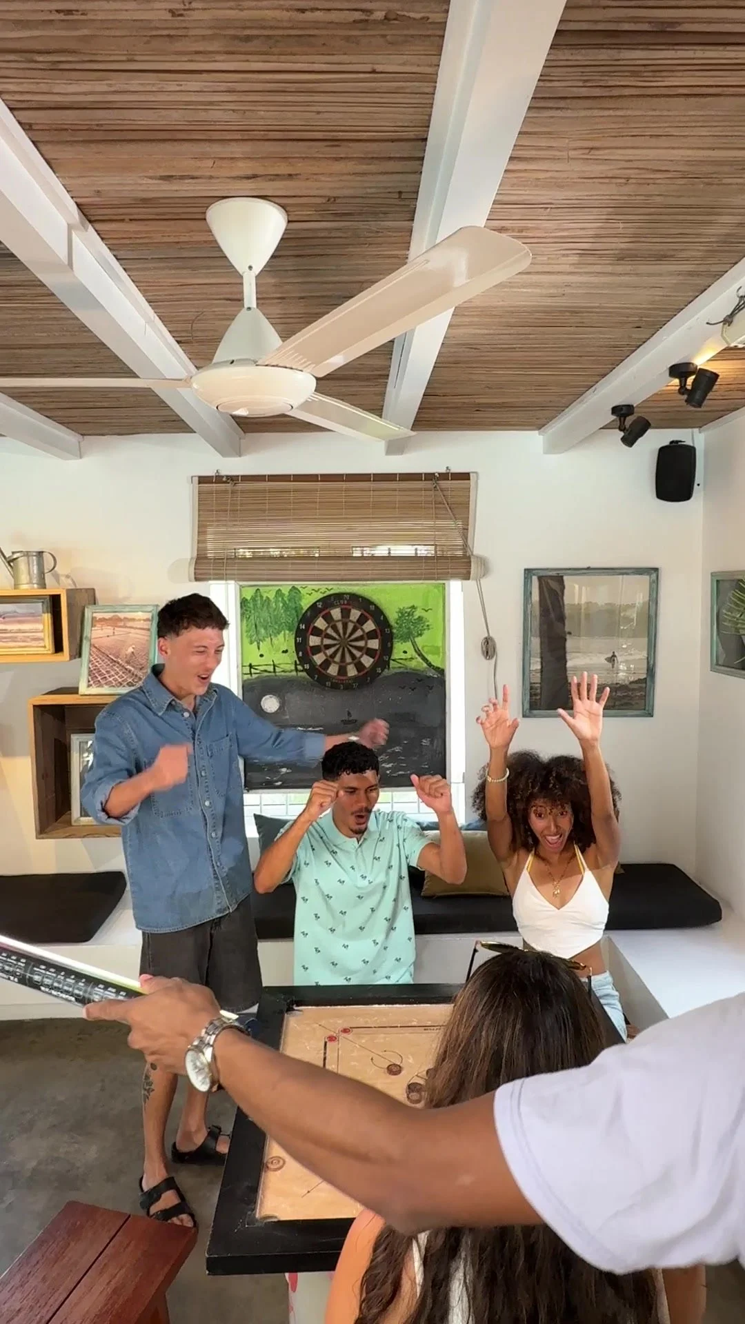 Crew holding the boom while the cast celebrates a take in the hotel lounge