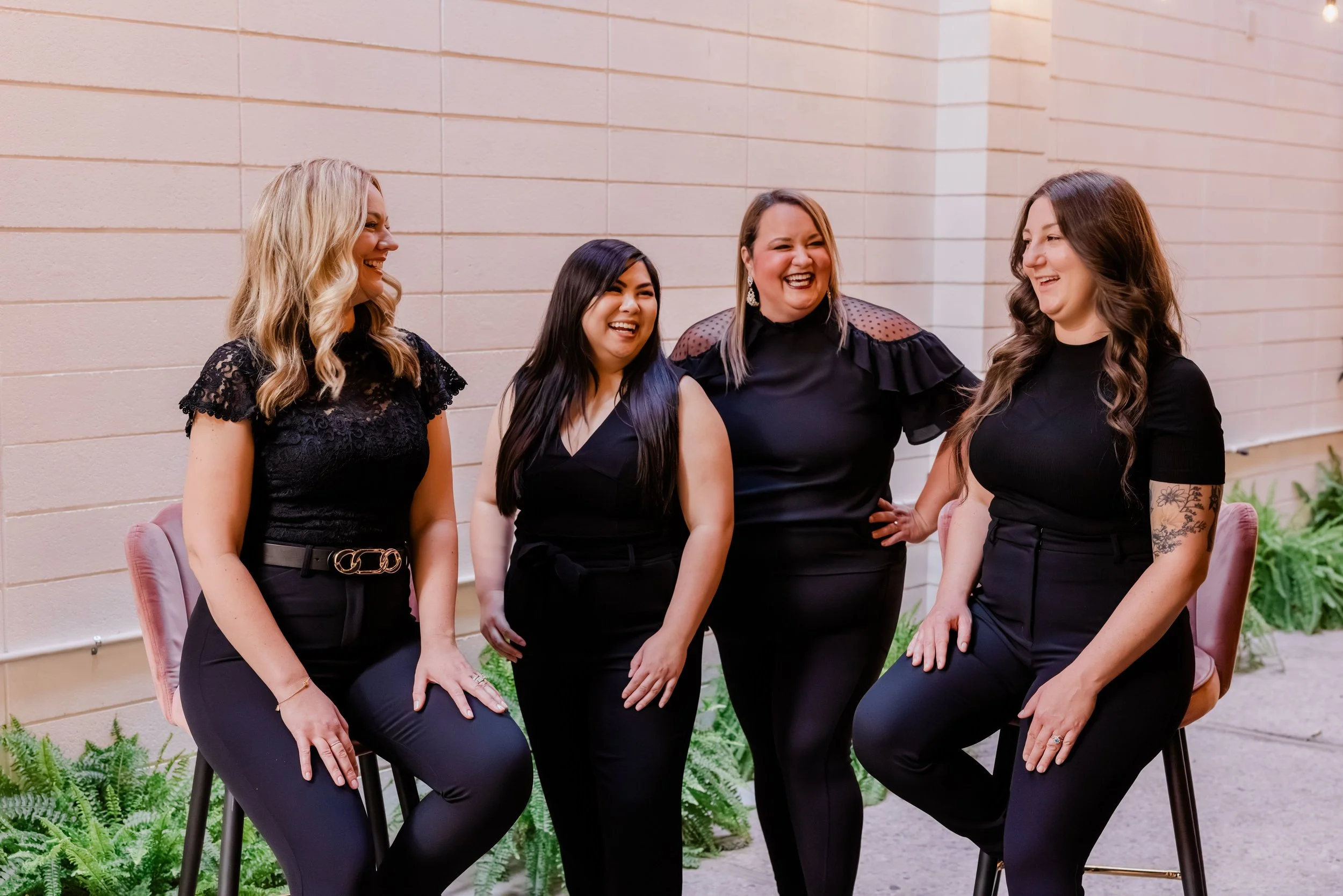 The Nine3One team laughing together at their coworking space in downtown Modesto CA