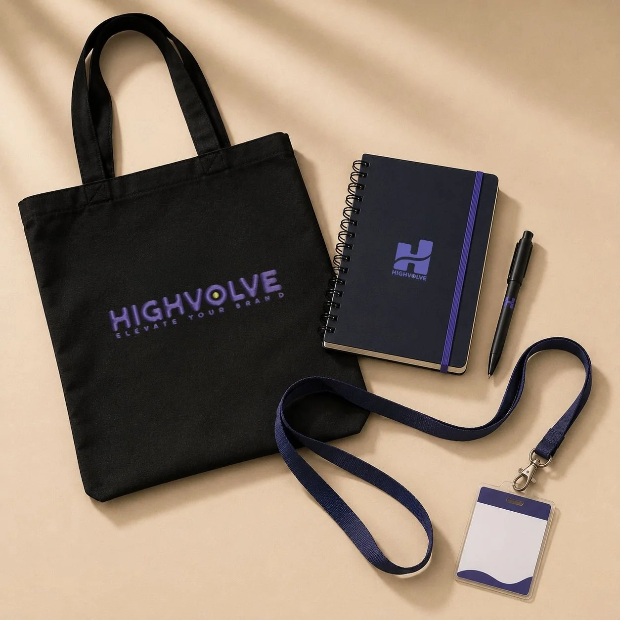 Trade show registration kit featuring a branded tote bag, notebook, pen, and attendee badge with lanyard arranged in a premium editorial flat lay.