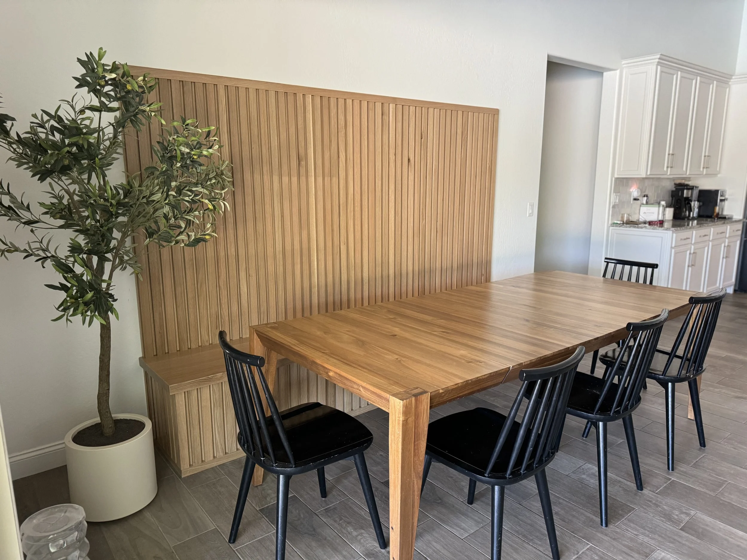 Completed KBK wood-slat dining wall with a built-in bench