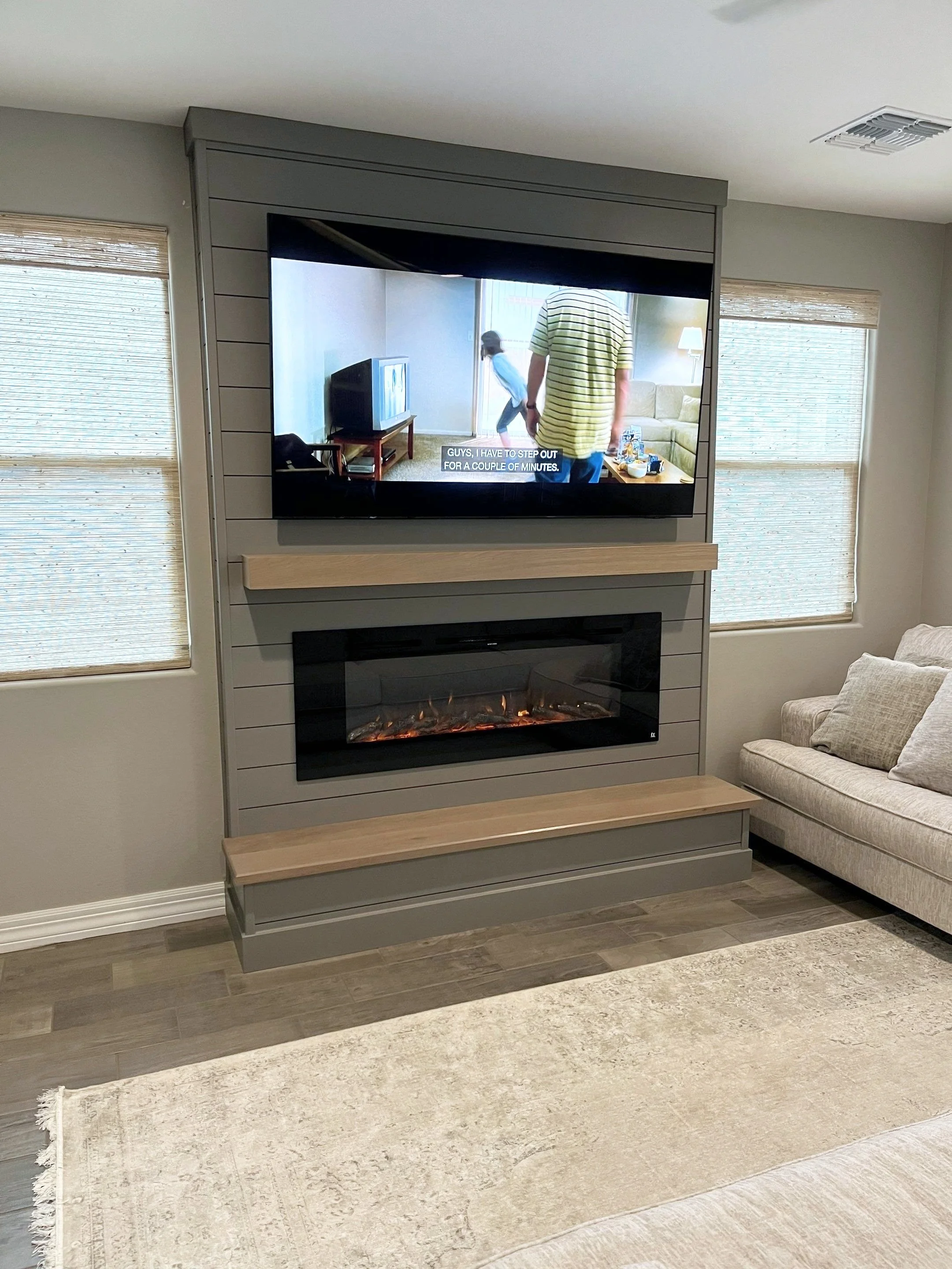 Gray shiplap fireplace wall and raised hearth, angled room view