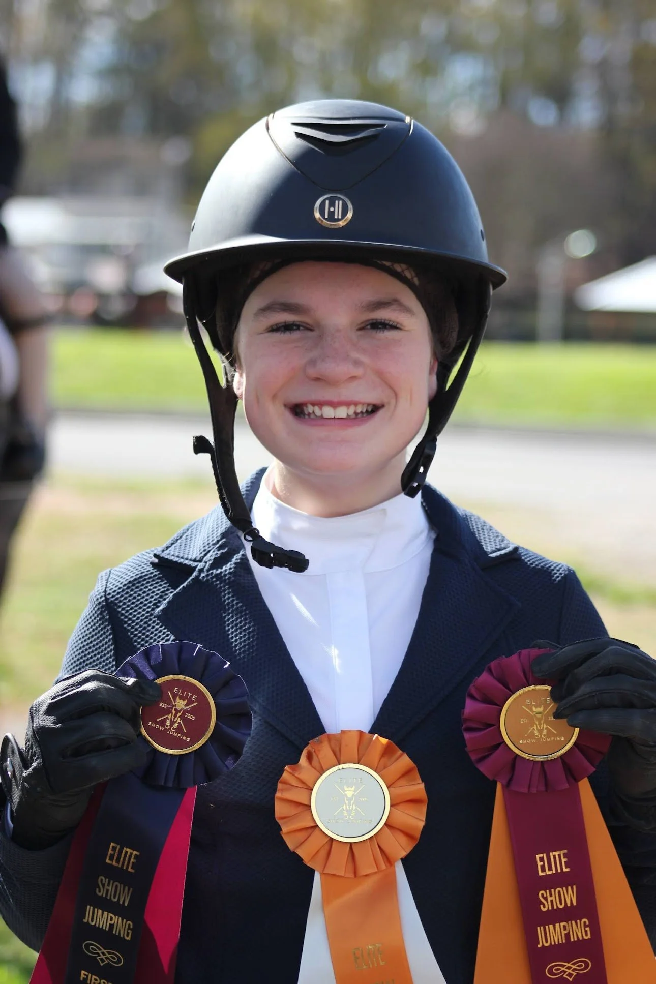 Blackrock rider holding show ribbons after competition