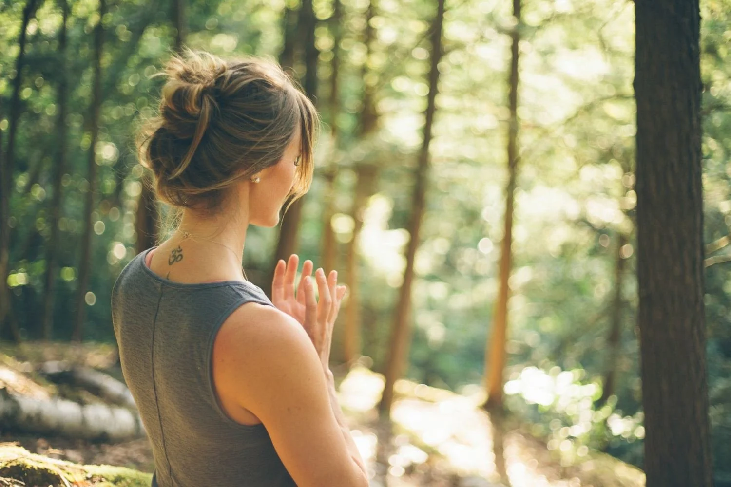 Genevieve in the forest with hands at her heart