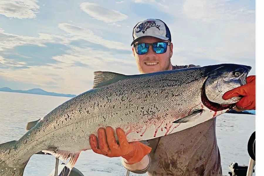 Owner and Captain Lucas Nisbet with a king salmon on Sitka Sound