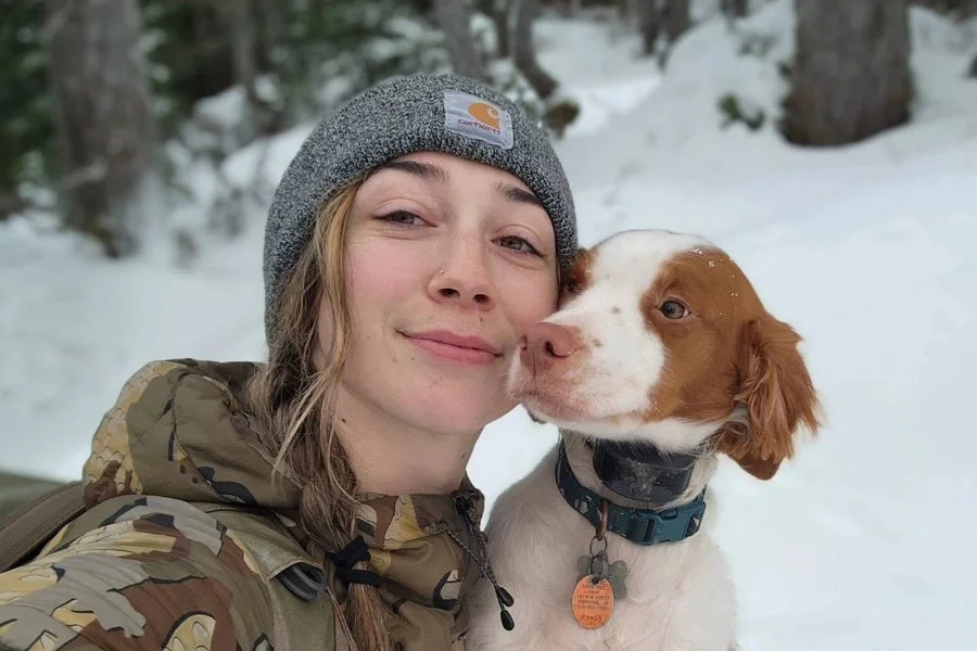 Captain Ahmika with her dog in the Southeast Alaskan backcountry