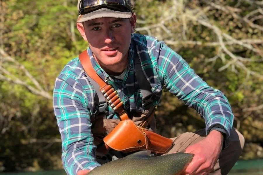 Captain Blake Lilly holding a char in an Alaskan river