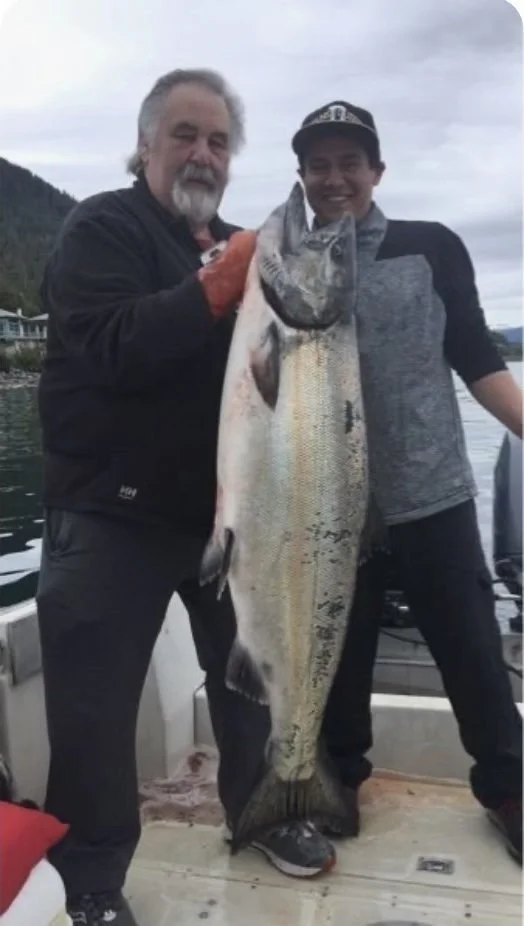 Guests aboard with a king salmon on Sitka Sound