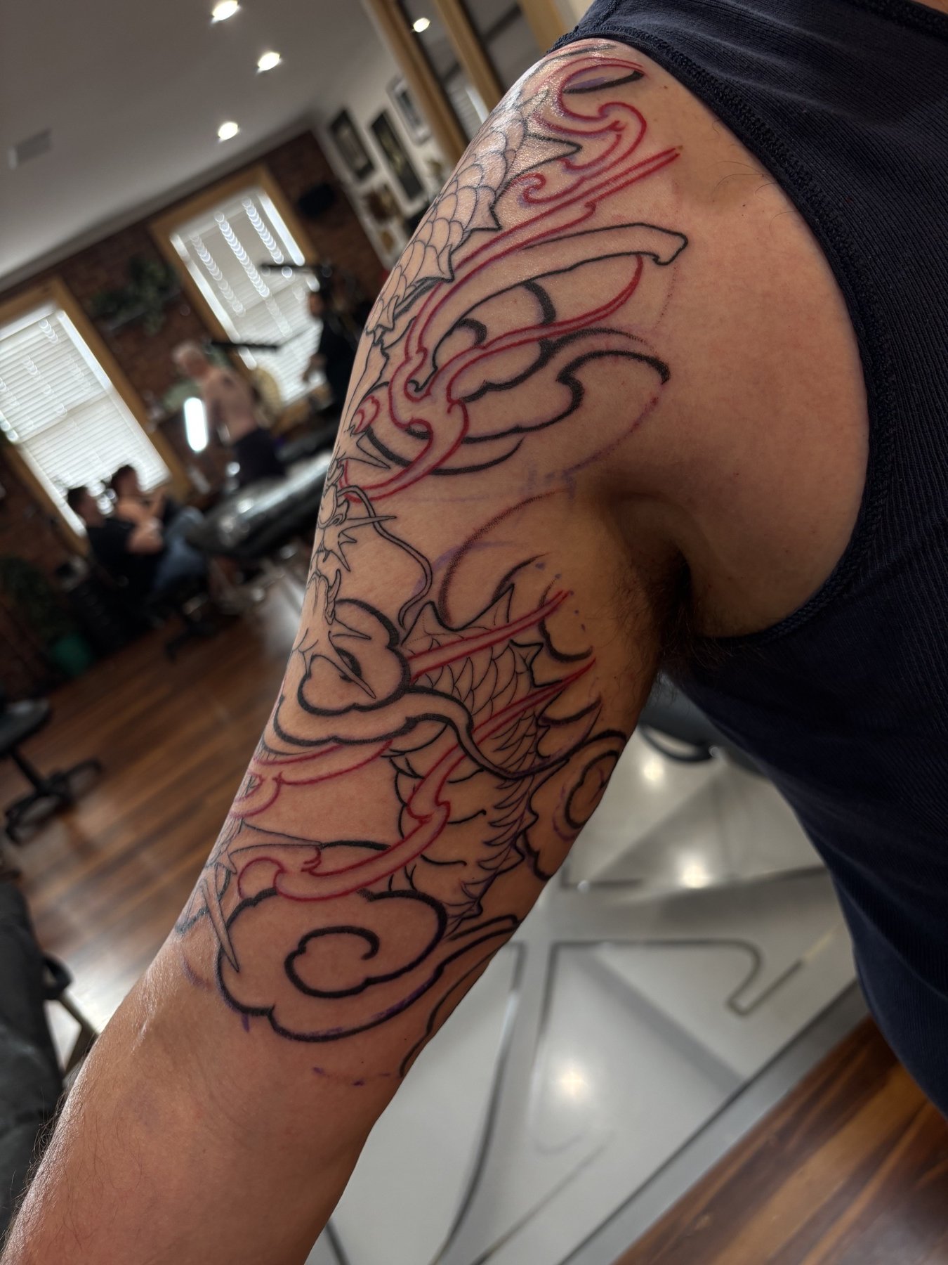 First-session outlines wrapping around the inside of Joel’s upper arm