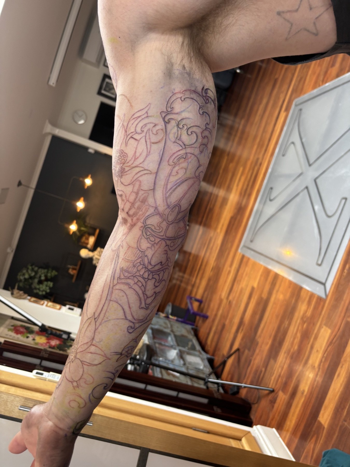 Initial grey lines marking out the tattoo design on Wade’s inner arm