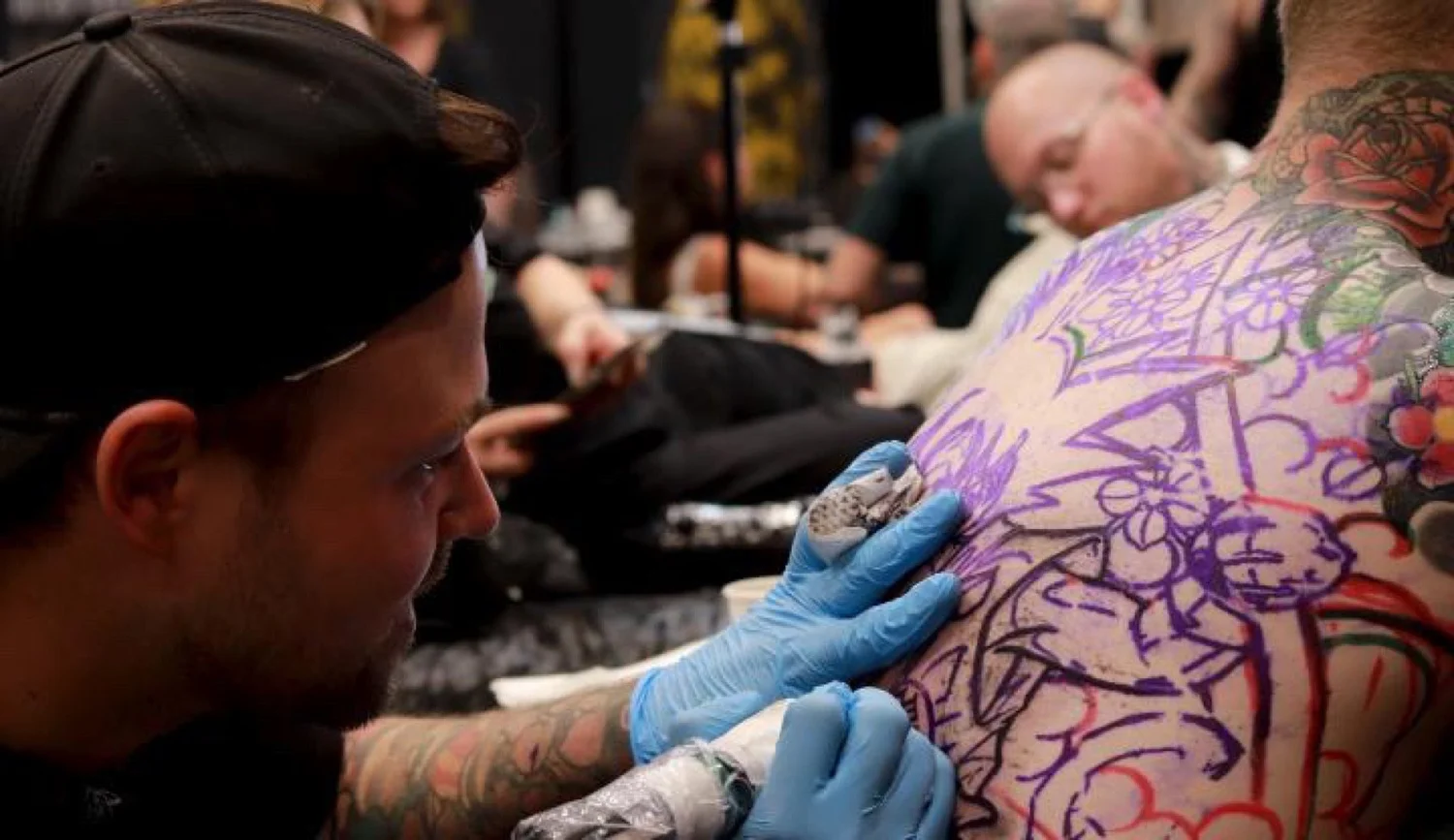 Nicklas Wong tattooing Levi’s Kid Goku backpiece at New Plymouth Tattoo Convention