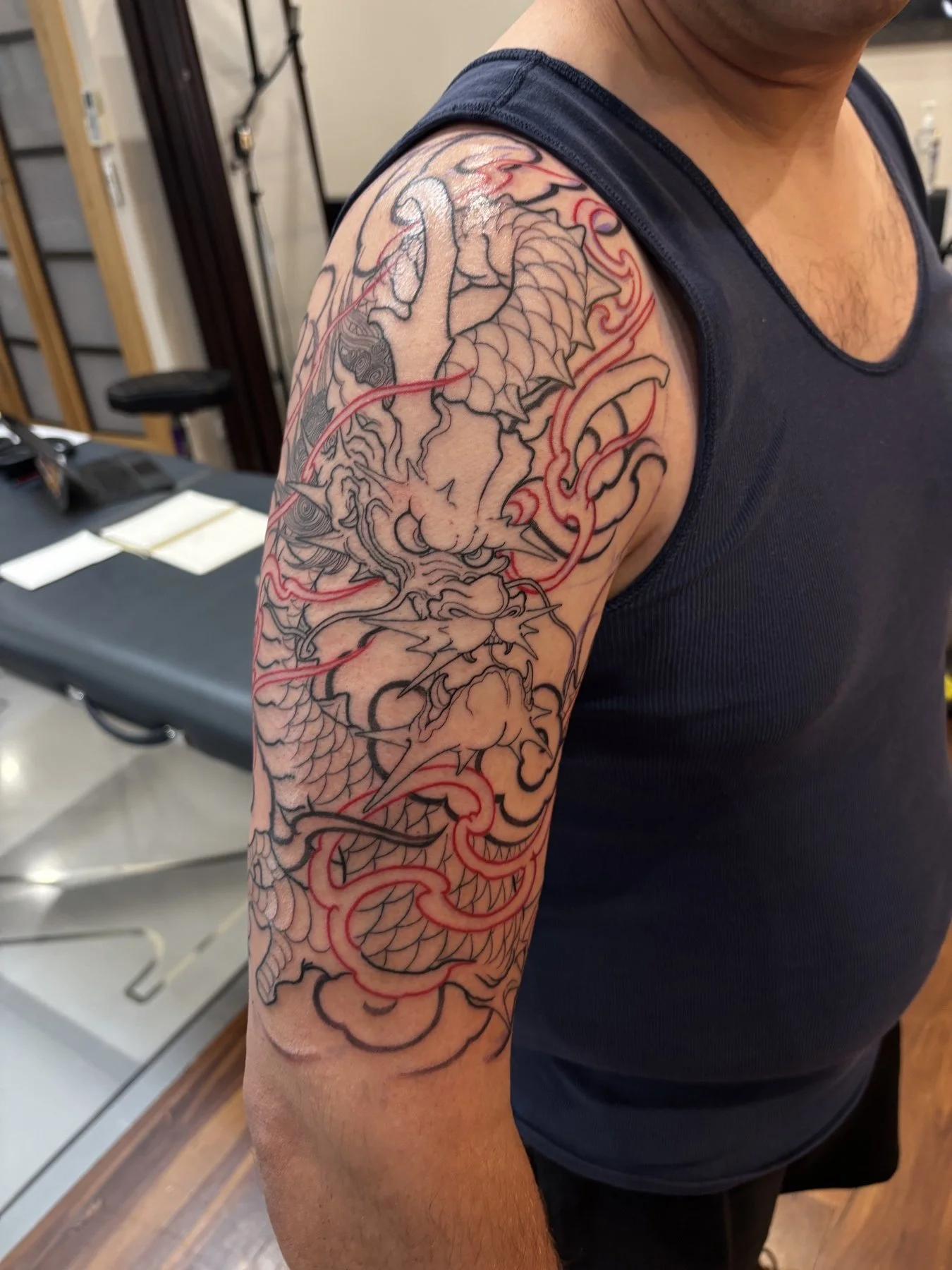 Dragon and flame outlines on Joel’s upper arm after the first session