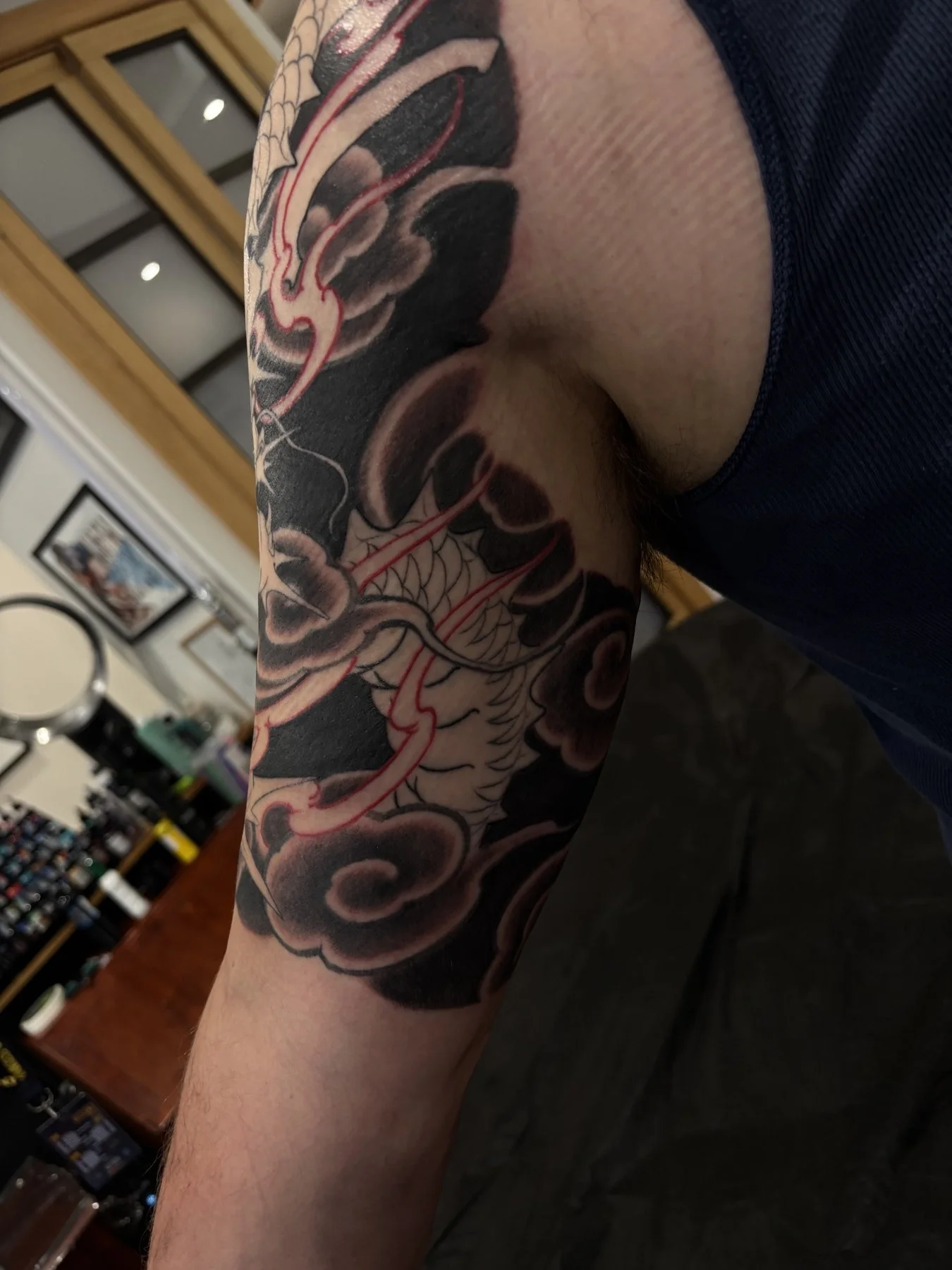 Dark background shading around the inner bicep with dragon and flames still outlined