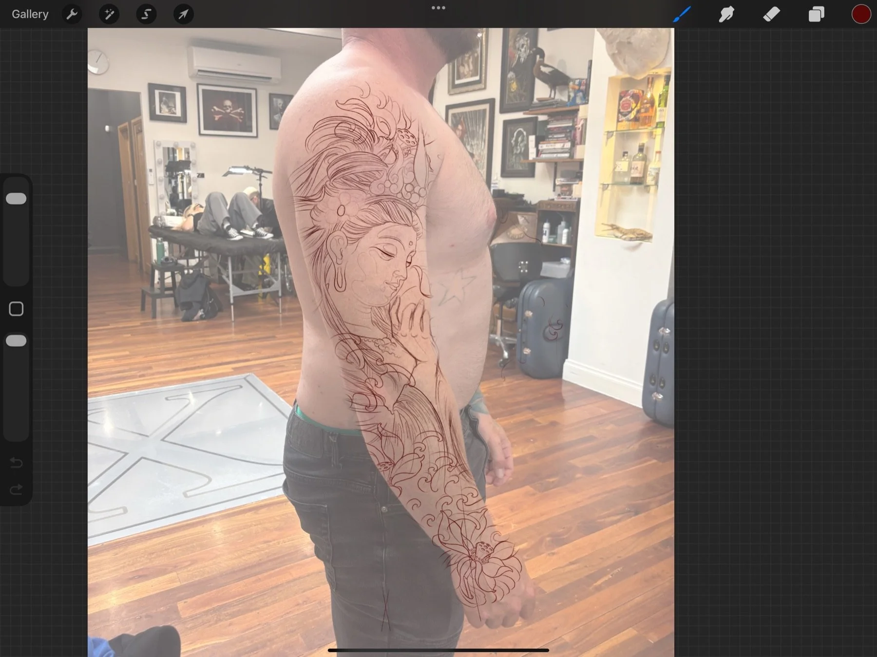 Digital Buddha and lotus sleeve design over a photograph of Wade’s arm