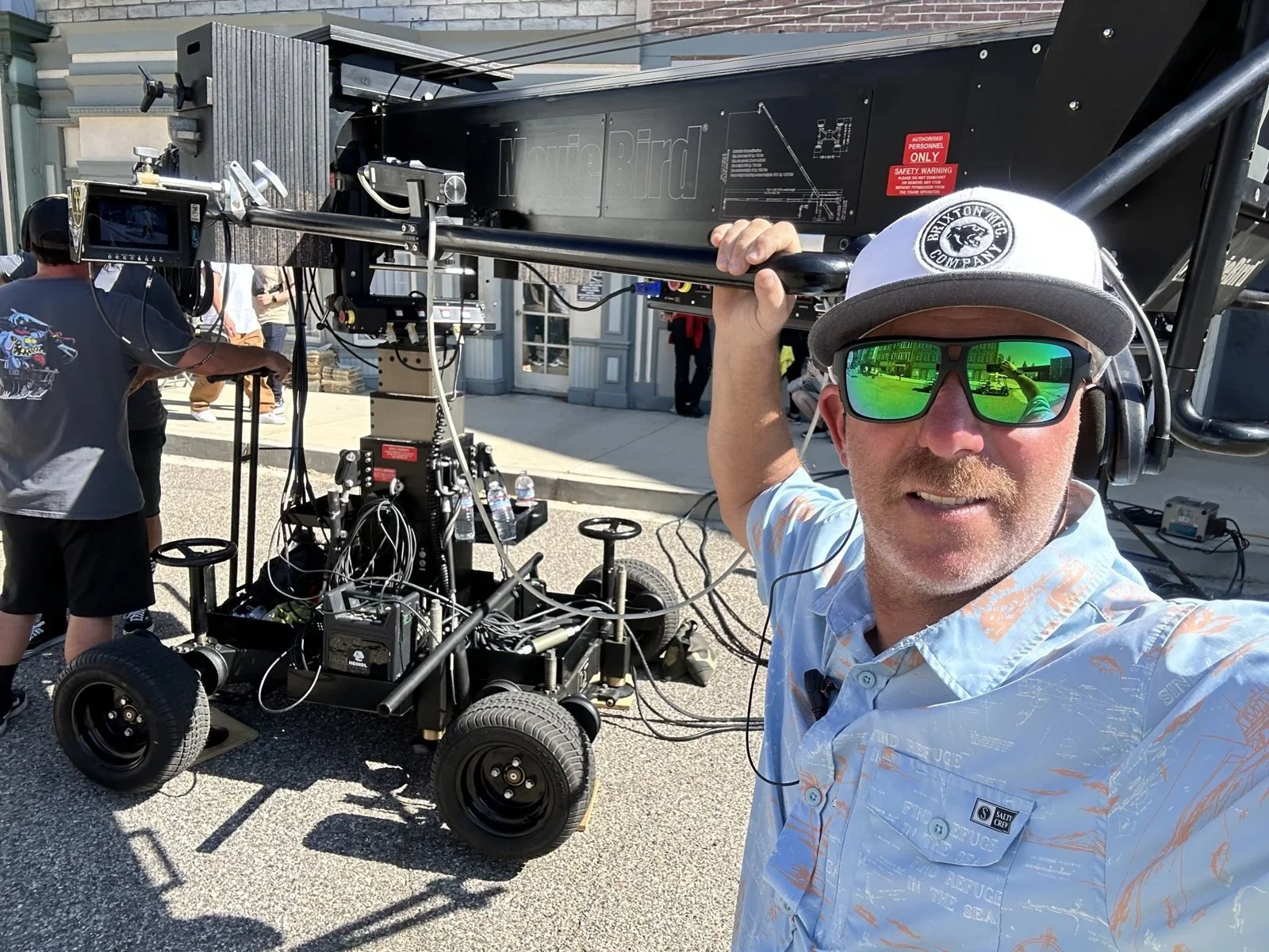 Eric "EZ" Zucker on set beside a camera car and crane