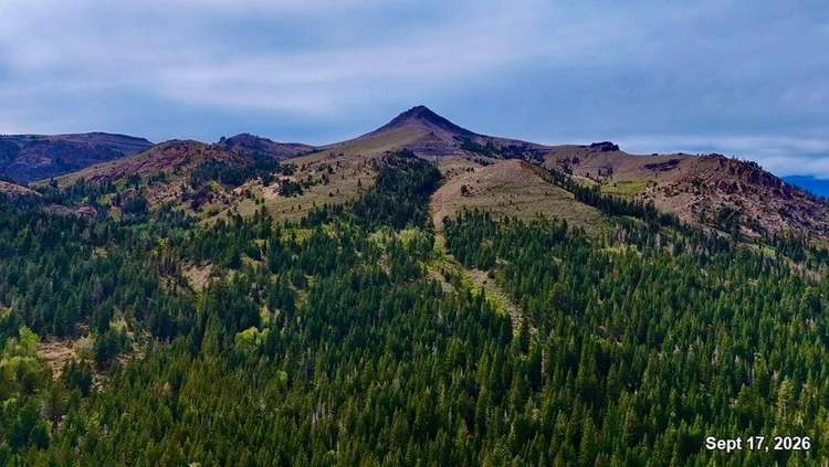 A pointed Sierra peak above green forested slopes beneath a cloudy sky. Date: Sept 17, 2026.