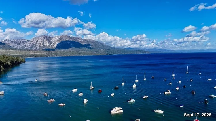 Moored sailboats and motorboats on deep blue Lake Tahoe, framed by a forested shore and mountains. Date: Sept 17, 2026.