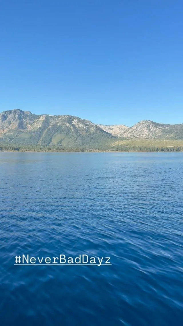 Deep blue Lake Tahoe with a distant Sierra ridgeline under a clear sky.