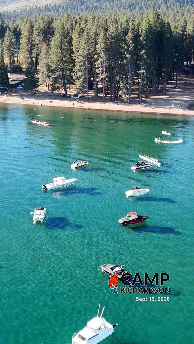 Turquoise water and moored boats beside Camp Richardson’s pine-lined beach.