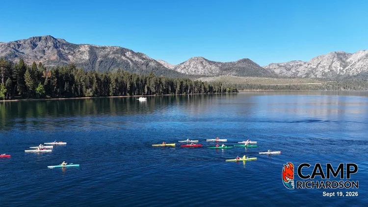 Colorful outrigger canoes on Lake Tahoe beneath the forested shoreline and Sierra mountains near Camp Richardson. Camp Richardson logo and publication date September 19, 2026.