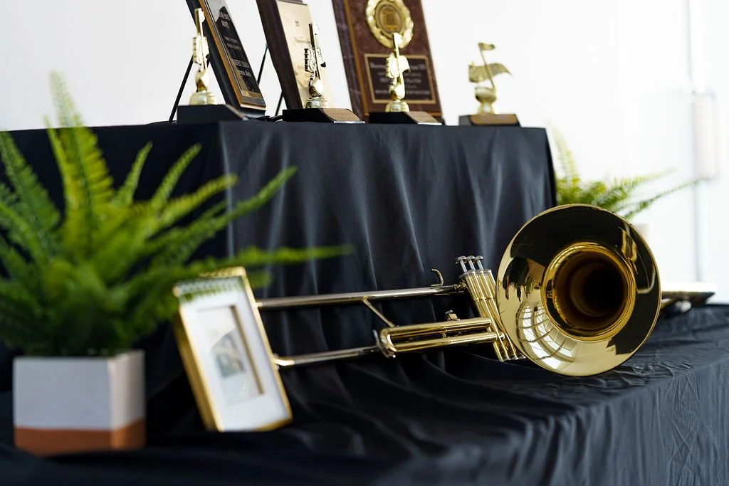 A trombone resting on a draped table — every detail means something