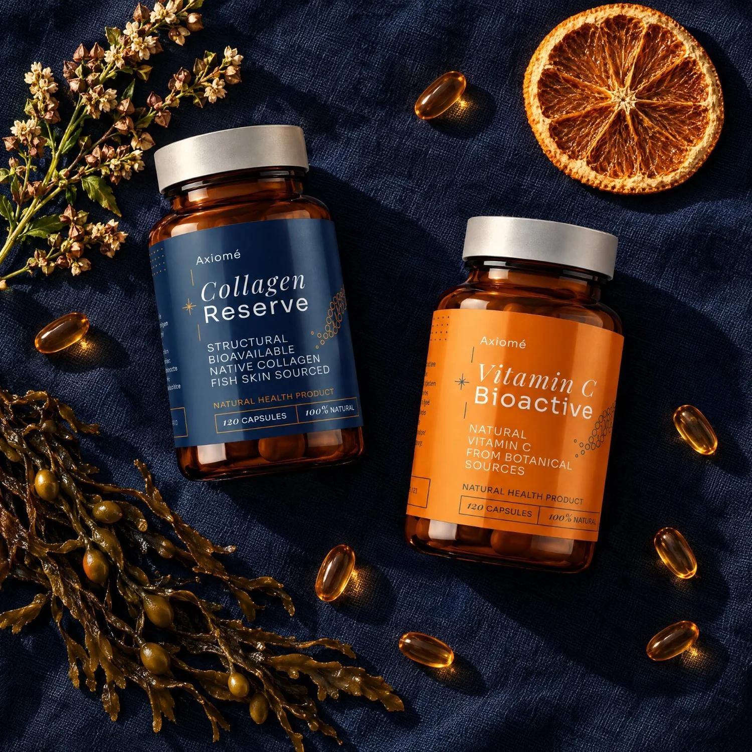 Axiomé bottles on navy linen with capsules, bitter orange, buckwheat and bladderwrack