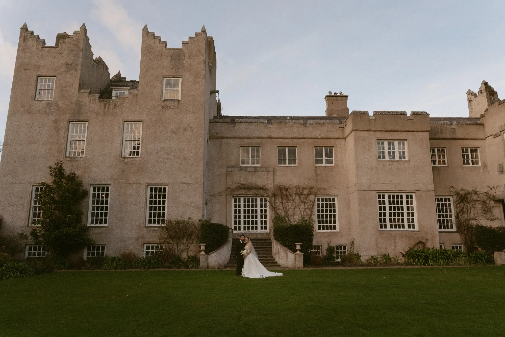 A couple standing together at Howth Castle after their Dublin wedding