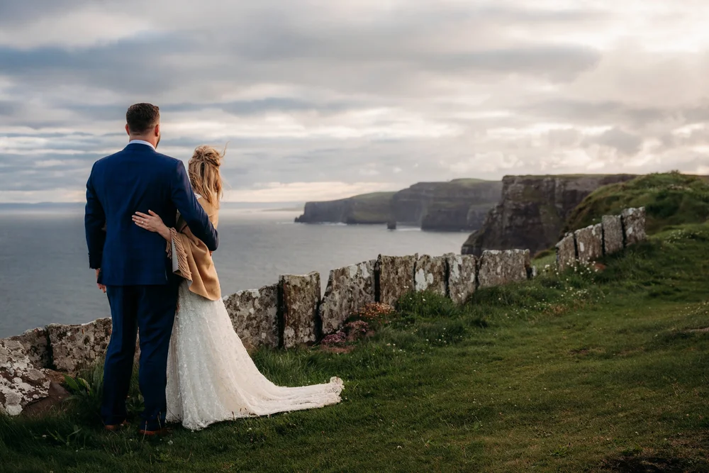 Jillian and Alex sharing a romantic moment at sunrise on the Cliffs of Moher