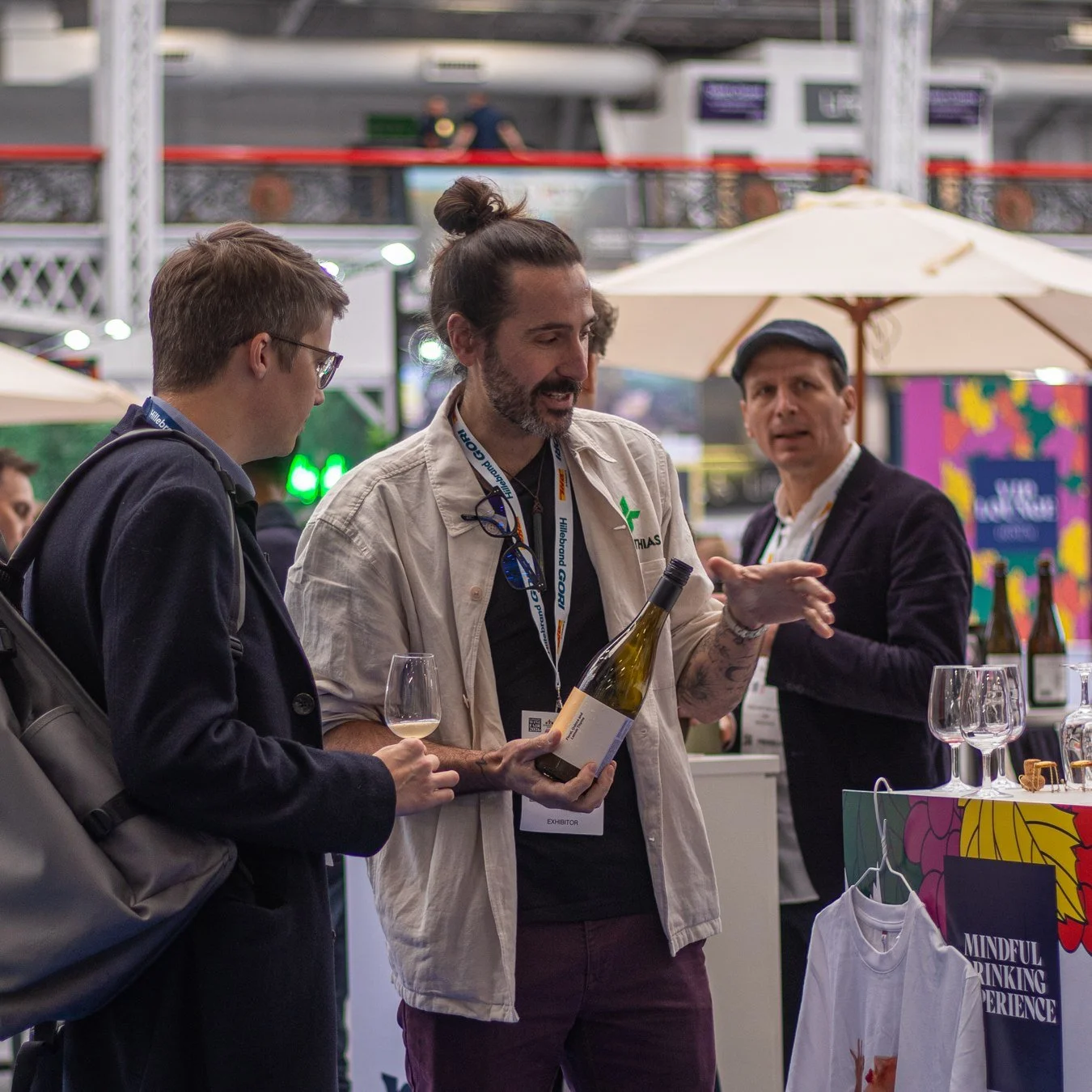 Matthias presenting a bottle to fellow exhibitors on the London Wine Fair trade floor