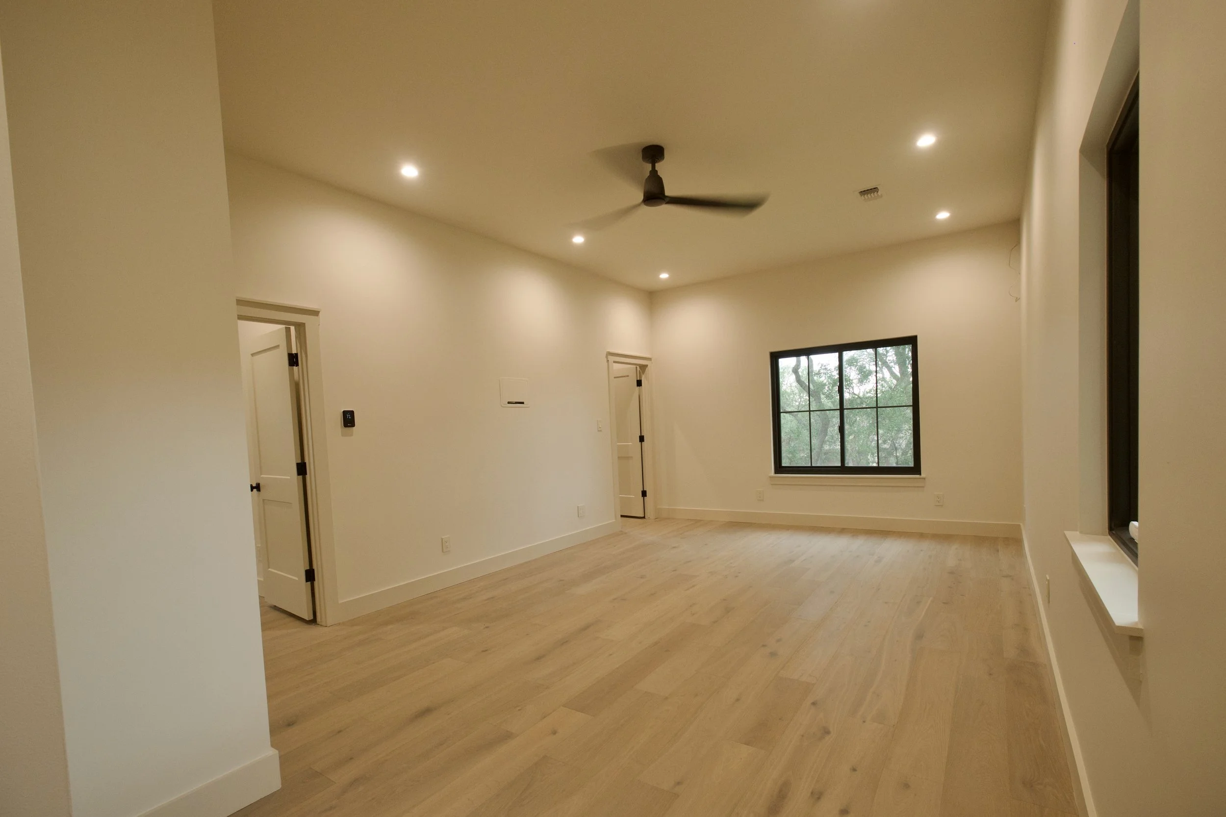 Angled view of the media room showing depth and entry with a feature window