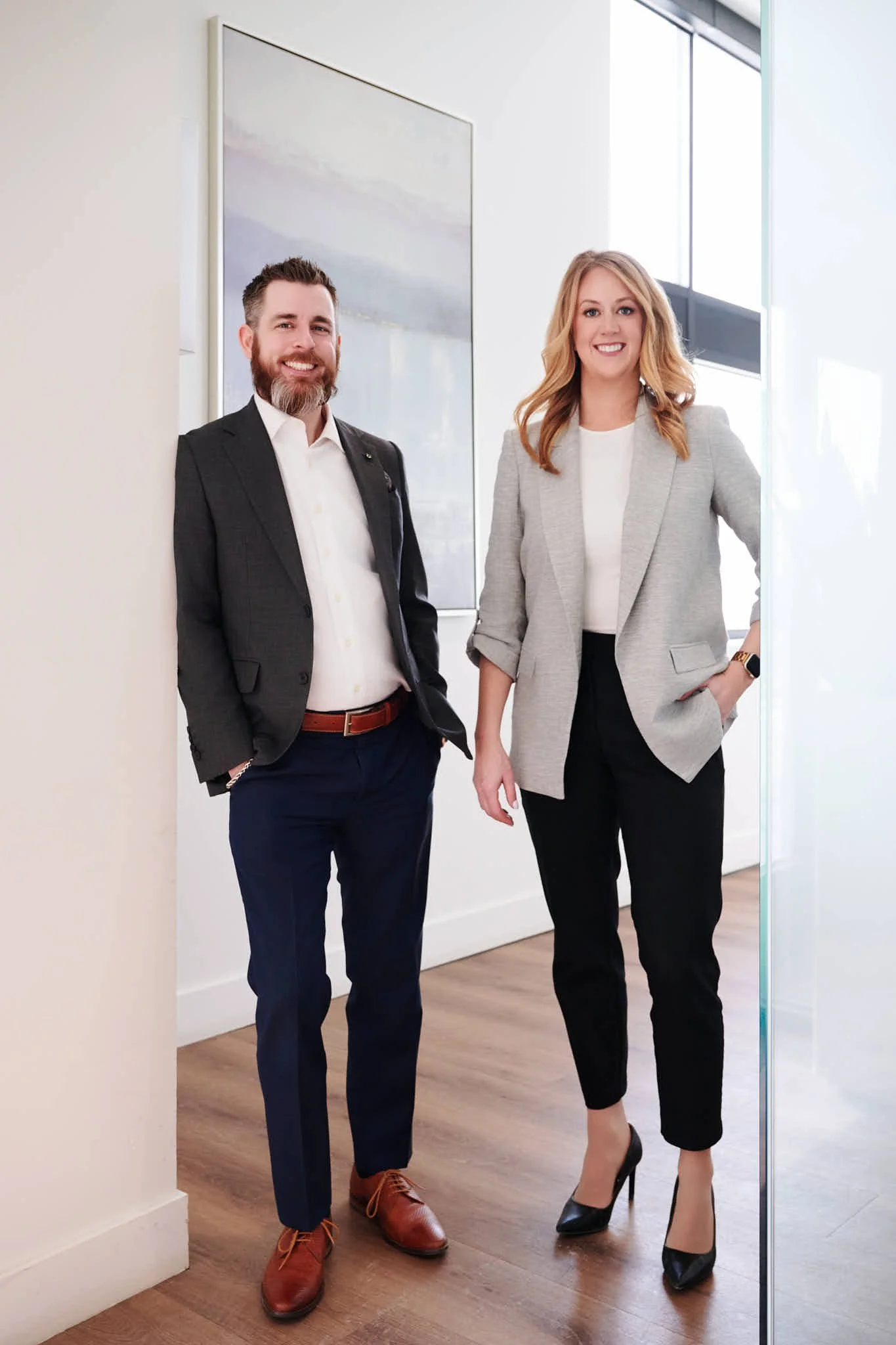 The two partners of Chimuk Landry standing in the hallway of their office