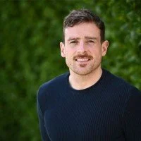 Kieran Lillis outdoors in a navy jumper