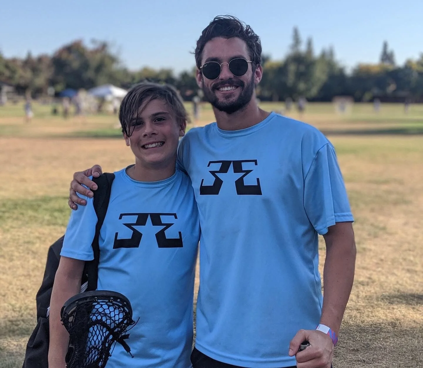 Logan with a Bay Elite lacrosse player at a tournament, 2019