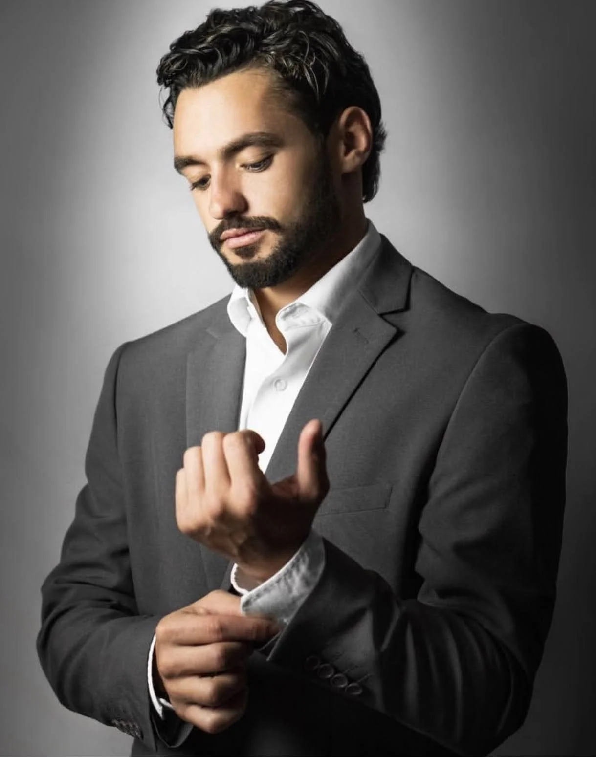 Logan in a studio portrait, grey suit, 2024