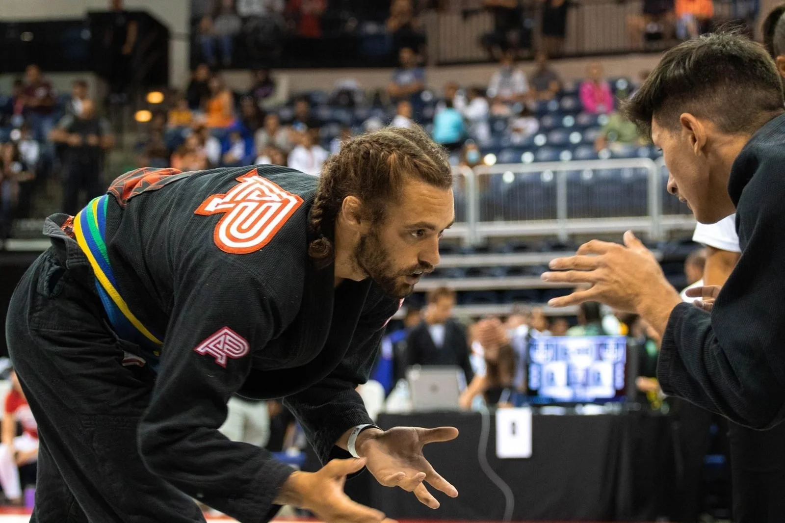 Logan coaching mat-side at a jiu jitsu tournament