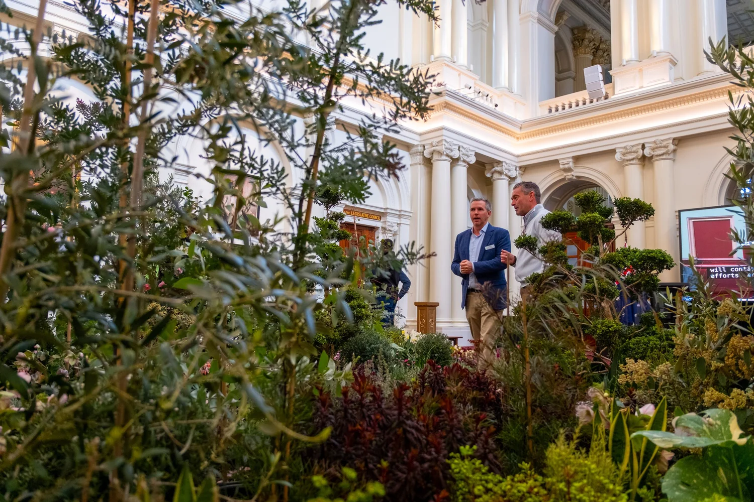 Visitors among garden installations inside Victorian Parliament