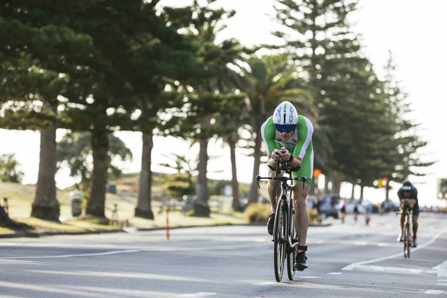 Mark Bowstead riding the Tauranga Half bike course along the flat, pine-lined coast road at Mount Maunganui