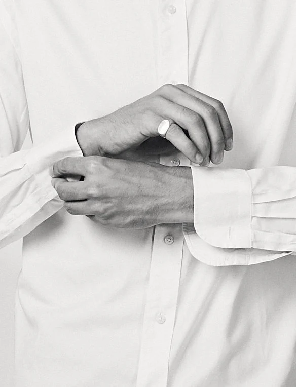 Black and white fashion detail of a crisp white shirt