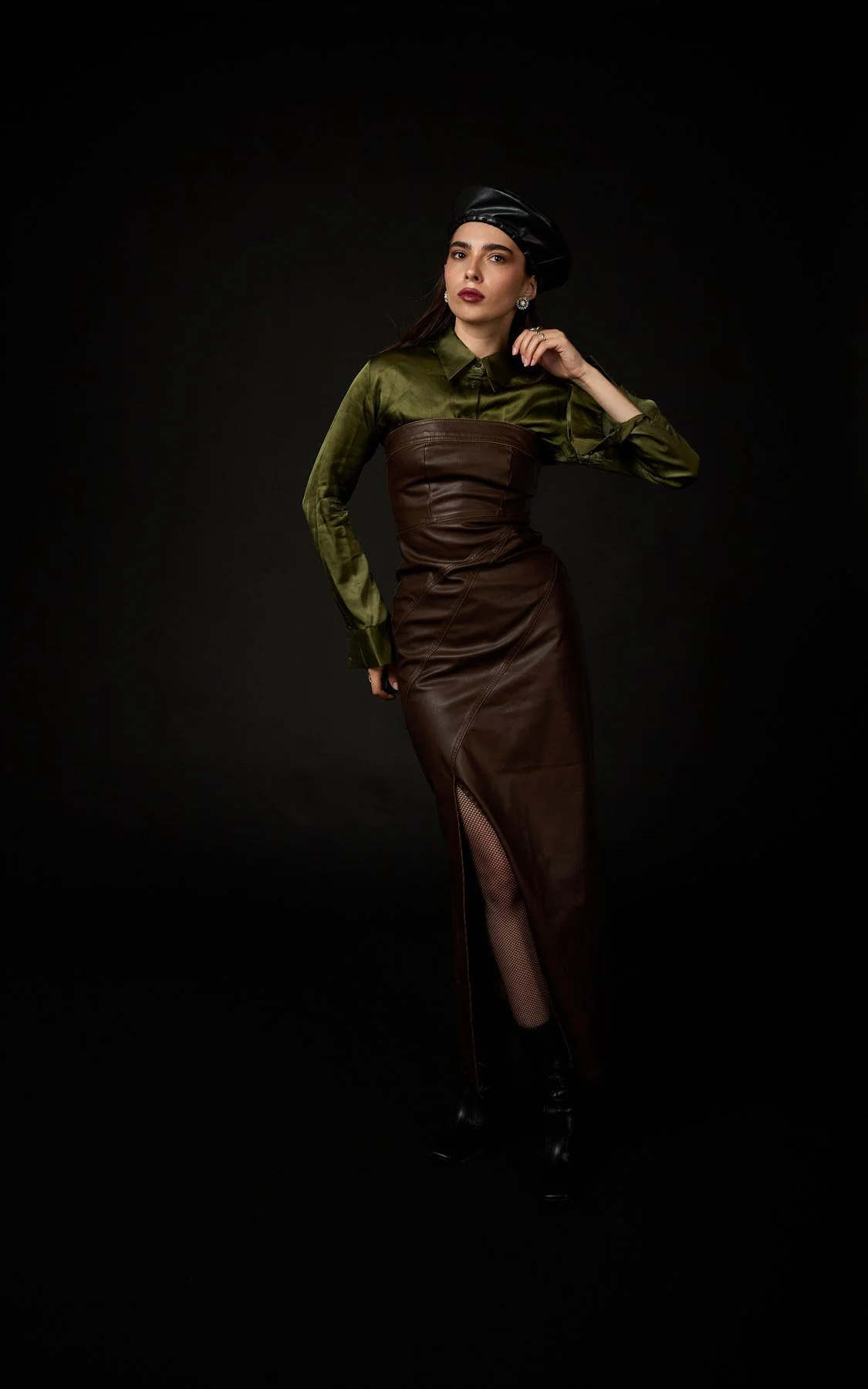 Fashion portrait in an olive shirt and leather skirt