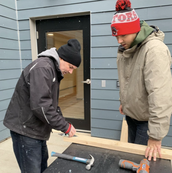 Life Redesign Coach supporting a resident in daily activities at CONNECT Hamilton