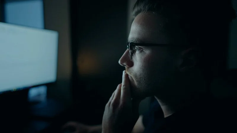 Analyst reviewing data at night